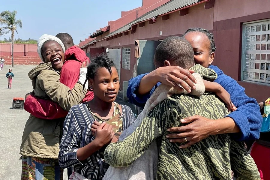 A family reunited, embracing after a loved one was found
